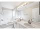 Clean and bright bathroom featuring double sinks, tub/shower combo, and modern lighting at 9721 Fredericksburg Rd, Tampa, FL 33635