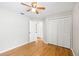 Bedroom with wood floors, ceiling fan, a double door closet, and ensuite bathroom entrance at 9721 Fredericksburg Rd, Tampa, FL 33635