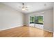 This bright bedroom includes wood floors, natural light, and screened lanai at 9721 Fredericksburg Rd, Tampa, FL 33635