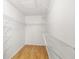 Walk-in closet features laminate wood flooring and metal shelving at 9721 Fredericksburg Rd, Tampa, FL 33635