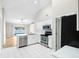 Bright kitchen featuring white cabinets, stainless steel appliances, and a scenic lake view at 9721 Fredericksburg Rd, Tampa, FL 33635
