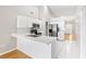 Bright kitchen features white cabinetry, stainless steel appliances, and eat-in counter at 9721 Fredericksburg Rd, Tampa, FL 33635