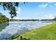 Scenic view of the lake and its tranquil surroundings from the property's edge at 9721 Fredericksburg Rd, Tampa, FL 33635