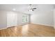 Bright living room with neutral walls, new flooring, ceiling fan, and front door at 9721 Fredericksburg Rd, Tampa, FL 33635