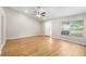Bright living room with neutral walls, new flooring, ceiling fan, and large window at 9721 Fredericksburg Rd, Tampa, FL 33635