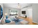 Open living room boasts wood flooring, neutral decor, and sliding glass doors to a screened lanai at 9721 Fredericksburg Rd, Tampa, FL 33635