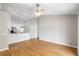 Open living room features wood flooring with access to kitchen and view of entryway at 9721 Fredericksburg Rd, Tampa, FL 33635