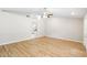 Bright living room with neutral walls, new flooring, and ceiling fan at 9721 Fredericksburg Rd, Tampa, FL 33635