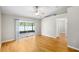 Main bedroom with hardwood floors and a sliding glass door overlooking the tranquil lake at 9721 Fredericksburg Rd, Tampa, FL 33635