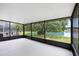 Screened patio with scenic views of lake and lush backyard, providing a serene outdoor retreat at 9721 Fredericksburg Rd, Tampa, FL 33635