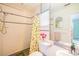 Bright bathroom with a walk-in shower, and colorful shower curtain at 1022 Greenbriar Dr, Brandon, FL 33511