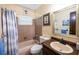 Cozy bathroom with a shower-tub, single vanity and wood-trimmed mirror at 1022 Greenbriar Dr, Brandon, FL 33511