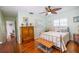 Cozy bedroom with hardwood floors, light green walls, and vintage furnishings at 1022 Greenbriar Dr, Brandon, FL 33511