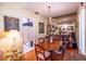 Charming dining room with hardwood floors and mirrored wall reflecting the chandelier at 1022 Greenbriar Dr, Brandon, FL 33511