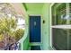 A charming front porch with a bright blue door shows a lovely flower garden at 1022 Greenbriar Dr, Brandon, FL 33511