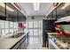 Modern kitchen featuring black cabinetry, a stainless-steel range, and tile flooring at 1022 Greenbriar Dr, Brandon, FL 33511