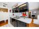 Spacious kitchen featuring sleek cabinetry, double sinks, and white tile flooring at 1022 Greenbriar Dr, Brandon, FL 33511