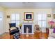 Traditional living room with fireplace, ceiling fan, and hardwood floors at 1022 Greenbriar Dr, Brandon, FL 33511