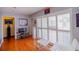 Bright living room featuring white furnishings, hardwood floors, and natural light at 1022 Greenbriar Dr, Brandon, FL 33511