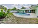 Gorgeous pool with stone paver decking, a white fence, and lovely lush landscaping at 1022 Greenbriar Dr, Brandon, FL 33511