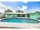 Beautiful backyard with a kidney-shaped pool and a green home exterior at 1022 Greenbriar Dr, Brandon, FL 33511