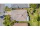 Aerial view of a single Gathering home with well-maintained landscaping and a symmetrical roof at 10801 Collar Dr, San Antonio, FL 33576