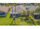 Aerial view of a well-maintained backyard with mature trees, lush green lawn and landscaping at 10801 Collar Dr, San Antonio, FL 33576