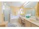 Bright bathroom with double sinks, a bathtub, a separate shower, and a large mirror at 10801 Collar Dr, San Antonio, FL 33576