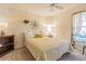Cozy bedroom with a ceiling fan, bright natural light and a comfortable bed at 10801 Collar Dr, San Antonio, FL 33576