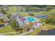 Aerial shot of community pool surrounded by golf course, clubhouse and manicured lawns at 10801 Collar Dr, San Antonio, FL 33576