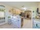 View of a kitchen with stainless steel appliances, breakfast bar and tiled flooring with an open view to living room at 10801 Collar Dr, San Antonio, FL 33576