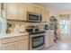 Well-lit kitchen featuring modern appliances, ample cabinet space and a window for natural light at 10801 Collar Dr, San Antonio, FL 33576