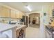 Bright kitchen featuring a stainless steel refrigerator, tile floors, and an open view to the living room at 10801 Collar Dr, San Antonio, FL 33576