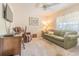 Comfortable living area with a sofa, recliner, ceiling fan, and a well-lit window providing natural light at 10801 Collar Dr, San Antonio, FL 33576
