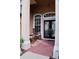 Inviting front porch featuring double doors, brick flooring, and comfortable rocking chairs at 10908 Sailbrooke Dr, Riverview, FL 33579