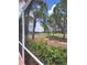 Beautiful golf course view seen from the screened-in patio with lush landscaping and mature palm trees in the background at 10908 Sailbrooke Dr, Riverview, FL 33579