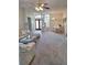 Spacious living room with plush seating, piano, and views of the front entrance at 10908 Sailbrooke Dr, Riverview, FL 33579