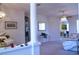 Bright living room featuring a piano, column, and open layout at 10908 Sailbrooke Dr, Riverview, FL 33579