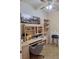 Functional office space offers ample built-in shelving, desk, and natural light for productivity at 10908 Sailbrooke Dr, Riverview, FL 33579