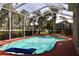 Screened-in pool area with palm trees and lounge seating at 10908 Sailbrooke Dr, Riverview, FL 33579