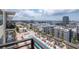 Scenic balcony view of the pool and cityscape under a vibrant sky, highlighting community amenities at 1120 E Kennedy Blvd # 1512, Tampa, FL 33602