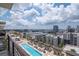 Beautiful balcony view of pool and surrounding community on a sunny day with light clouds at 1120 E Kennedy Blvd # 1512, Tampa, FL 33602