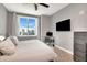 Cozy bedroom with large window, city view, workstation, and a ceiling fan at 1120 E Kennedy Blvd # 1512, Tampa, FL 33602