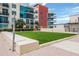 Exterior shot of a modern apartment building with a well-maintained green space and contemporary architecture at 1120 E Kennedy Blvd # 1512, Tampa, FL 33602