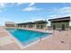 Large community pool with multiple changing cabanas surrounded by paved deck, perfect for relaxation and recreation at 1120 E Kennedy Blvd # 1512, Tampa, FL 33602