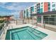 Rooftop hot tub with stairs and railing, offering a relaxing experience with views of the surrounding city and pool at 1120 E Kennedy Blvd # 1512, Tampa, FL 33602