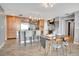 Gourmet kitchen with granite countertops, stainless steel appliances, and an island with seating and a dining table at 1120 E Kennedy Blvd # 1512, Tampa, FL 33602