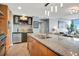 Gourmet kitchen with granite countertops, stainless steel appliances, a center island, and an open-concept layout at 1120 E Kennedy Blvd # 1512, Tampa, FL 33602
