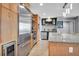 Gourmet kitchen featuring granite countertops, stainless steel appliances, and wooden cabinets at 1120 E Kennedy Blvd # 1512, Tampa, FL 33602