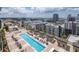 Aerial view of a community pool area with lounge chairs and cabanas, offering a relaxing and luxurious urban living experience at 1120 E Kennedy Blvd # 1512, Tampa, FL 33602